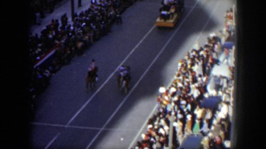 1951: people riding horses down the street for a parade. TEXAS