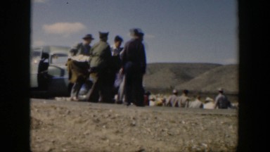 1951: group of servicemen transporting a body on stretcher from a vehicle