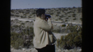 1951: woman filming family near the side of the road TEXAS