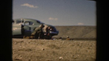 1951: people roaming around a parked car deserted area TEXAS