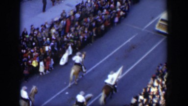 1951: Horses and People Walking in a Street Parade with an Audience Texas