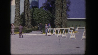 1954: a couple walking arm in arm in front of a hotel
