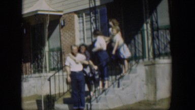 1954: Adults and Children Pose and Hug on Stairway Leading to Front Doors