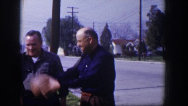 1954: a family is playing ball standing in the front yard tossing the ball