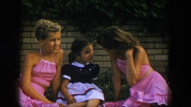 1954: children sitting out in the grass. NEVADA