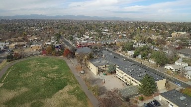 birds eye view flying over a small, flat city without skyscrapers COLORADO