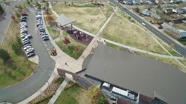 aerial view of a business with a gathering of people near the parking lot
