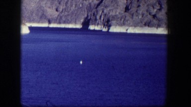 1954: A Full Dam on a Hot Day in Nevada with Glass-Like Blue Water and Floating Markers