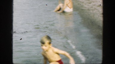 1947: a child playing in a body of murky water CONNECTICUT