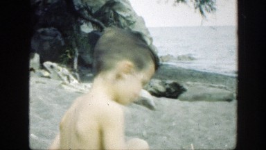 1947: Child Sitting at Beach and Smiles at Camera Connecticut
