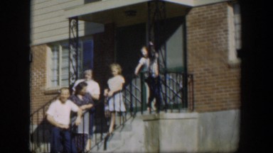 1954: People Lined Up Against a Railing Waving Happily to the Audience Nevada
