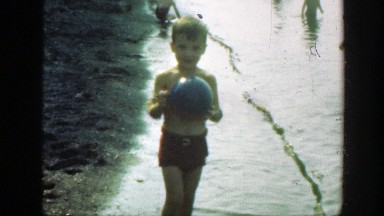 1947: little boy throwing a toy ball by the lake. CONNECTICUT