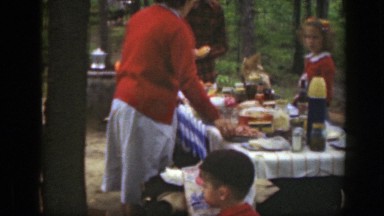 1949: family outside enjoying each others company and eating a variety of food