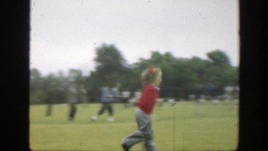 1949: a girl running and picking up a ball in a sweater MASSACHUSETTS