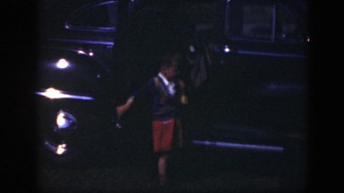 1949: people with each other in a lot with cars nearby and dressed in church