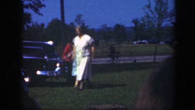 1949: mother with children outdoor children running away in green area
