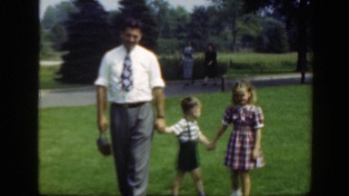 1948: father and his children all outside, enjoying a day in the sunshine.