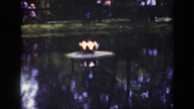 1948: people standing around a large pond with something in the center of it