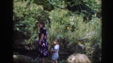 1948: a woman and two children standing outside in a lush setting WASHINGTON DC