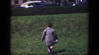 1949: young boy running gleefully in his school uniform. CINCINNATTI OHIO