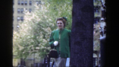 1949: a woman wearing green walking outside CINCINNATTI OHIO