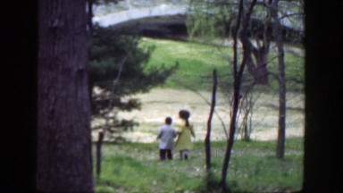 1949: Little Boy and Little Girl Walking in the Woods Down a Hill, Cincinnati Ohio