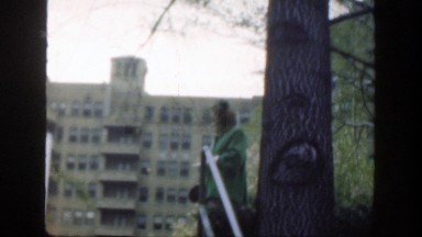 1949: sister guiding brother down city steps while mother laughs. CINCINNATTI
