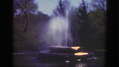 1949: structure spraying up water in the center with animals to the side
