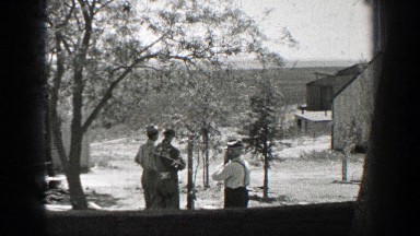 1937: Three Men Standing Outside Building in Winter California