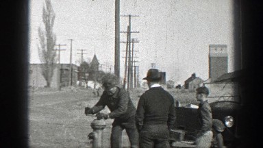 1937: Two Men and a Boy Opening a Fire Hydrant Near Their Old-Time Car
