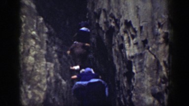 1937: group walks up rock face into crevasse CALIFORNIA
