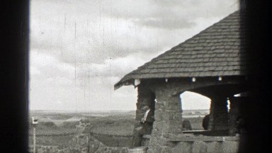 1938: person sitting near a stone structure that is above a valley WASHINGTON