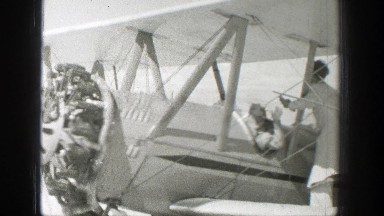 1939: workmen performing maintenance on a biplane WYOMING