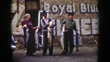 1939: people holding out large fish for demonstration. WYOMING