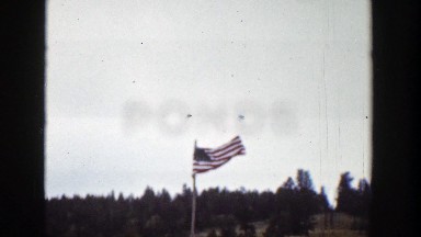 1939: American Flag Waving in the Wind on a Cloudy Day in Wyoming