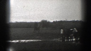 1939: man rides a warmblood horse across a muddy field MONTANA