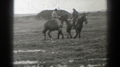 1939: a man and woman holding hands and riding horses MONTANA