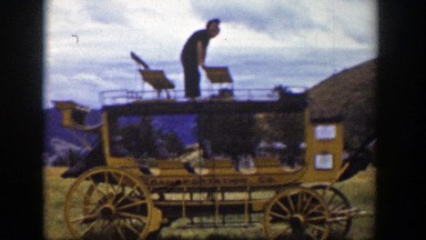 1939: Two People Climbing Over the Seat of a Wagon in Wyoming