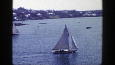 1948: Sailboat in the Water Next to a Shore with Houses in New York