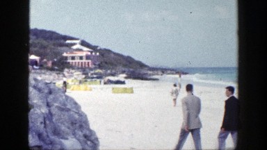 1948: two business men take a quick walk on the beach before going back to work.