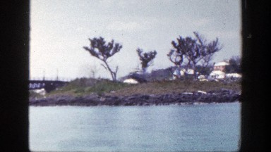 1948: View of a Small Island and Town from a Boat on a River in New York
