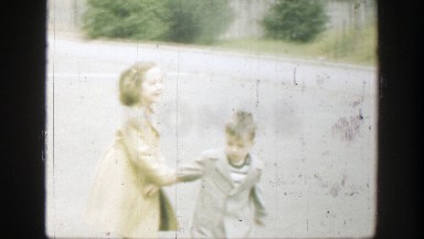 1949: Little Boy and Girl Running Down Driveway, Playing in Cincinnati Ohio