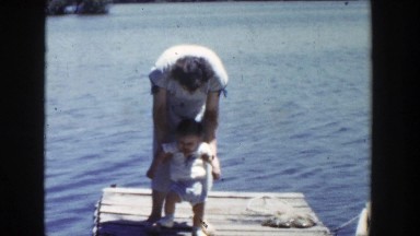 1953: Mother Helping Infant Walk on Dock Wisconsin