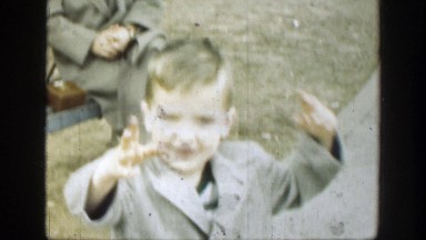 1949: Child in Park Walking Toward Camera Rubbing His Face