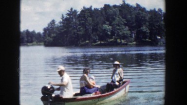 1953: people in a boat on the water moving fast. WISCONSIN