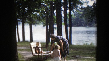 1953: a family with two small children hanging out next to a river WISCONSIN