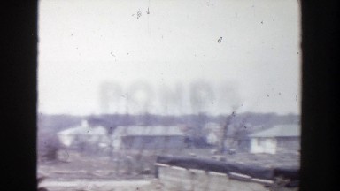 1956: dumping yard with thrown out objects heaped near to some buildings GRAND