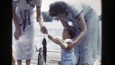 1953: young child holding fish caught WISCONSIN