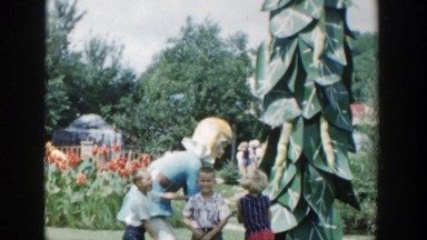 1954: a children standing next to a statue that moves with blonde hair WISCONSIN