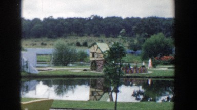 1954: woman and child strolling in a lovely park with a small pond. WISCONSIN